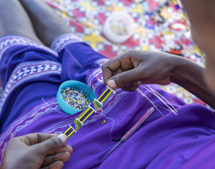 Making of handmade jewellery. Masai african women hands, top view, close up. Island of Zanzibar, Tanzania, Africa Making of handmade jewellery. Masai african women hands, top view, close up. Island of Zanzibar, Tanzania, East Africa